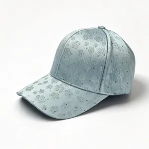 Elegant light blue rhinestone embroidered baseball cap, clover pattern detail close-up.