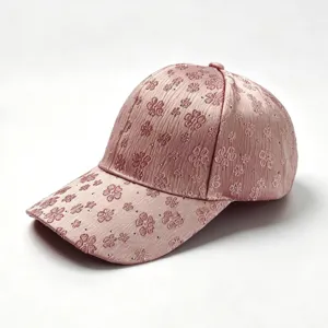 Close-up detail of stylish pink rhinestone embroidered floral baseball cap for women.
