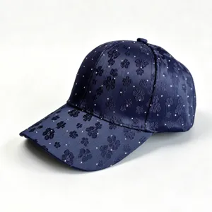 Stylish navy blue baseball cap with floral embroidery and rhinestone details for women.