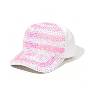 Detailopname van het sprankelende roze en iriserende strass-patroon op de witte pet.