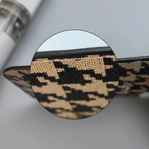 Close-up detail shot of houndstooth card holder edge, showing neat stitching and material.