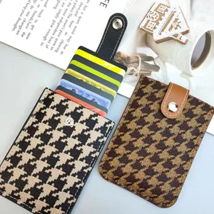 Detailed view of houndstooth card holder, showing multi-card slots and pull-out design.