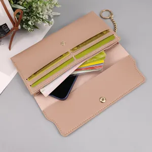 Pink long women wallet with multiple card slots snap closure and stylish chain detail.