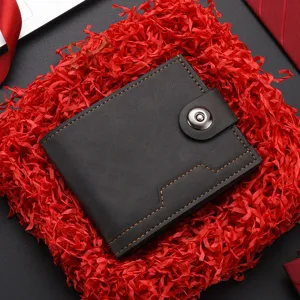 Men's short leather wallet detail view, featuring black soft texture and secure snap closure.