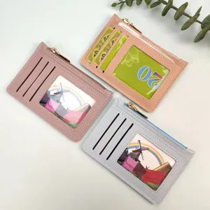 Detail view of slim women's PU leather card holder with clear ID window and zipper coin pocket.