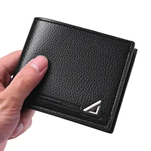 Detailed view of the men's black leather wallet, soft pebbled texture and metal triangular decor.