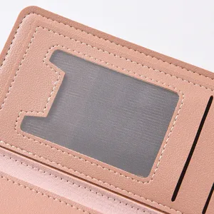 Pink PU leather wallet detail view showing transparent ID window and card slot design.