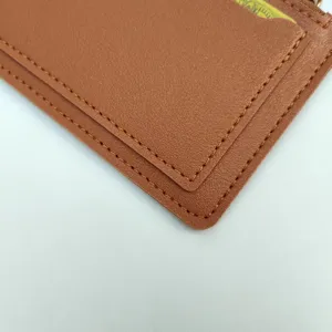 Close-up detail of the brown leather card holder showing neat stitching texture and slim card slots.