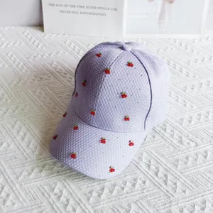 Detailed view of light purple waffle baseball cap with cute cherry and rhinestone embellishments.