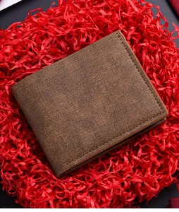 Close-up detail of retro brown men's short wallet with texture and fine stitching design.
