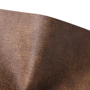 Close-up detail shot of the brown retro leather wallet texture and fine stitching craftsmanship.