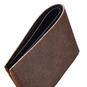Close-up detail shot of the brown textured folded wallet canvas showing fine craftsmanship.