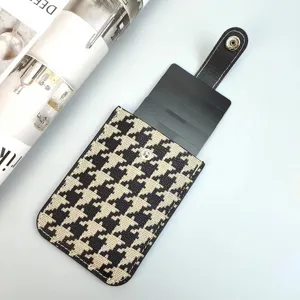Pull-out houndstooth card holder with black leather snap strap and multi-slot case.