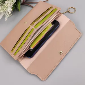 Detailed view of the pink long wallet interior showing multiple card slots and phone pocket.