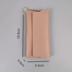 Close-up detail of women's long PU leather wallet with snap button and metal chain accessory.