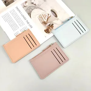 Detail view of compact zipper cardholders with multiple card slots in soft pastel colors.