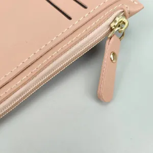 Pink PU leather card holder wallet detail with zipper and card slots, close up view.