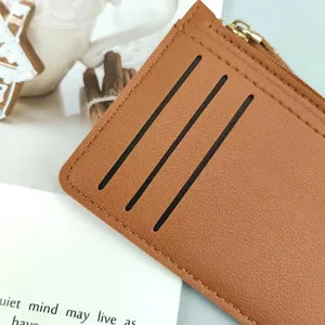 Brown leather card holder with zipper pocket and multi slots for daily use minimalist style.