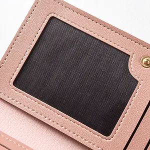 Close-up detail of pink women wallet interior, featuring clear ID window and snap button.