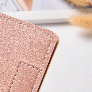 Pink leather long wallet detail close-up, stylish minimalist women purse texture and stitching.