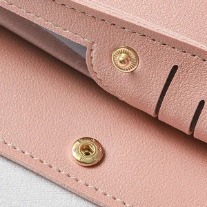 Detailed close-up view of pink leather long wallet snap button fine stitching accessory.