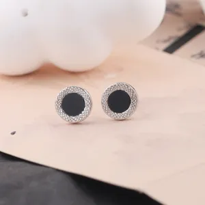 Minimalist round stud earrings with textured silver rim and black center for women daily wear.
