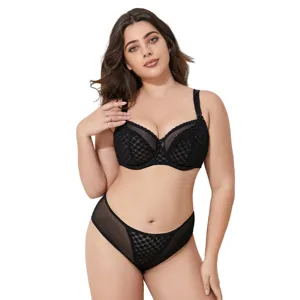 Plus size black lace bra and matching panties set detail showing delicate mesh design.