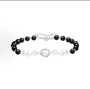 Fashionable black beaded bracelet with cute cartoon puppy pendant and silver butterfly charms.