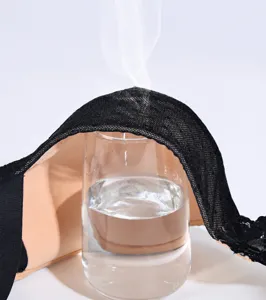 Close-up detail of lightweight breathable bra cup demonstrating superior airflow over water glass.