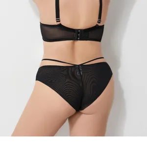 Detail shot of a black plus size lingerie set, featuring a sheer mesh bra and matching panties.