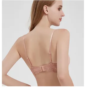 Detail view of women's pink lace bra showing back strap design and fine floral patterns.