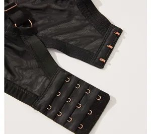 Close-up detail of black mesh plus-size bra back closure with rose gold metal hooks.