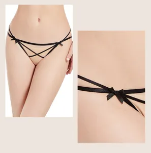 Close-up detail view of sexy women's sheer mesh low-rise thong panty with side black bow.