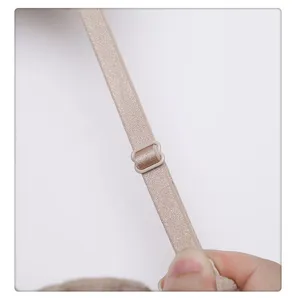 Close up of adjustable bra strap detail, elastic nude fabric with matching adjuster buckle.