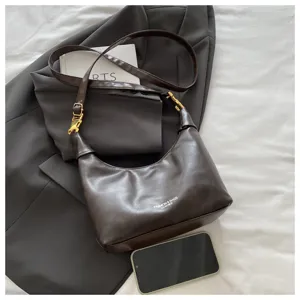Brown leather hobo shoulder bag detail, stylish crescent crossbody purse with metal hardware.