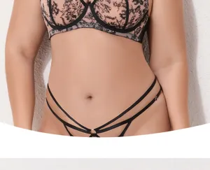 Close-up detail of plus size lace bra and cross strap panties, sexy mesh lingerie.