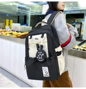 Campus style black and white backpack detail showing star pattern and cute mini pouch.