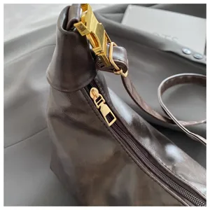 Detailed close-up view of the stylish brown PU leather retro dumpling shoulder bag.