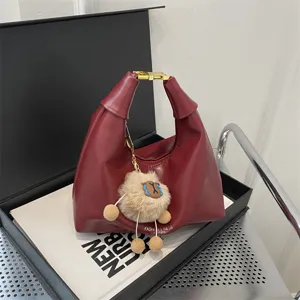 Red leather dumpling shoulder bag with cute plush pendant, stylish commuting crossbody bag for women