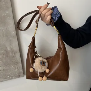 Retro brown PU leather hobo shoulder bag with cute plush pendant and chic chain strap.