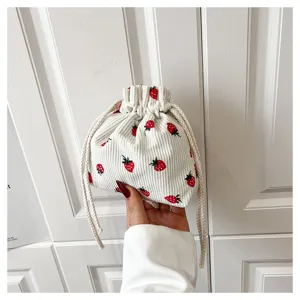 Cute strawberry corduroy drawstring bag, compact casual handbag with red fruit print detail.