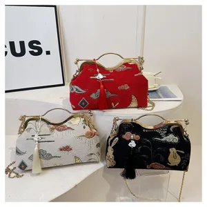 Chinese style vintage embroidered handbag with metal frame and elegant tassel crossbody bag.