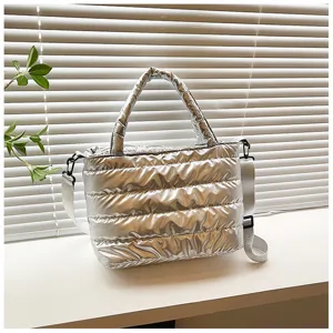 Silver padded tote bag detail, winter casual crossbody shoulder bag with wide strap.