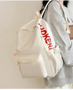 Close-up of white casual campus backpack, minimalist large capacity bookbag with side pocket detail.