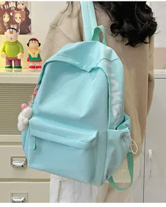 Detail shot of a light blue student backpack, showcasing large capacity and casual daily style.