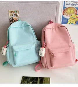 Minimalist casual student backpack with cute bear charm, lightweight large capacity bag.