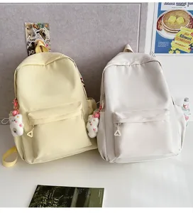 Casual school student backpack detail, lightweight daily daypack with cute bear pendant.