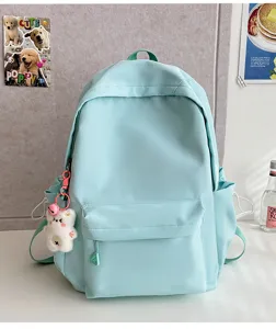 Mint green casual school backpack with cute bear pendant, lightweight large capacity daypack.