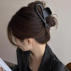 Matte black hair claw clip for women, large geometric shark clip for elegant back styling.