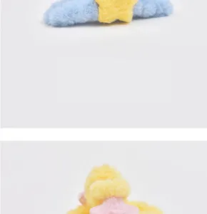 Plush star hair claw clip detail shot, soft fuzzy material, cute blue and yellow accessory.